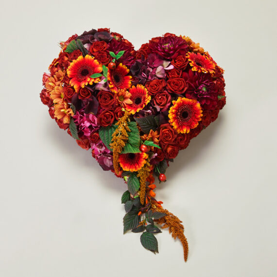 En fargerik hjerteformet blomsterdekorasjon.
